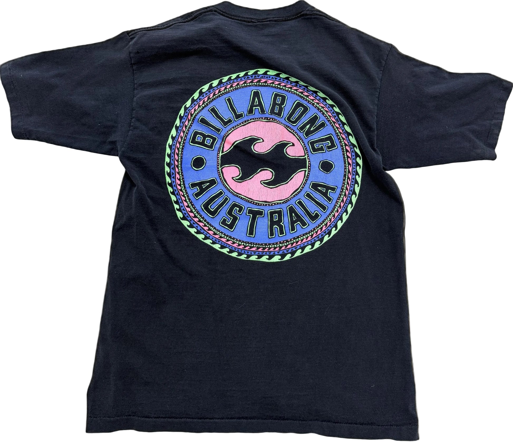 A vintage Billabong Australia t-shirt shown from the back, featuring a large circular graphic with a pink and black wave logo on a blue background, surrounded by a green and purple border.