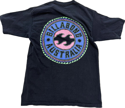A vintage Billabong Australia t-shirt shown from the back, featuring a large circular graphic with a pink and black wave logo on a blue background, surrounded by a green and purple border.